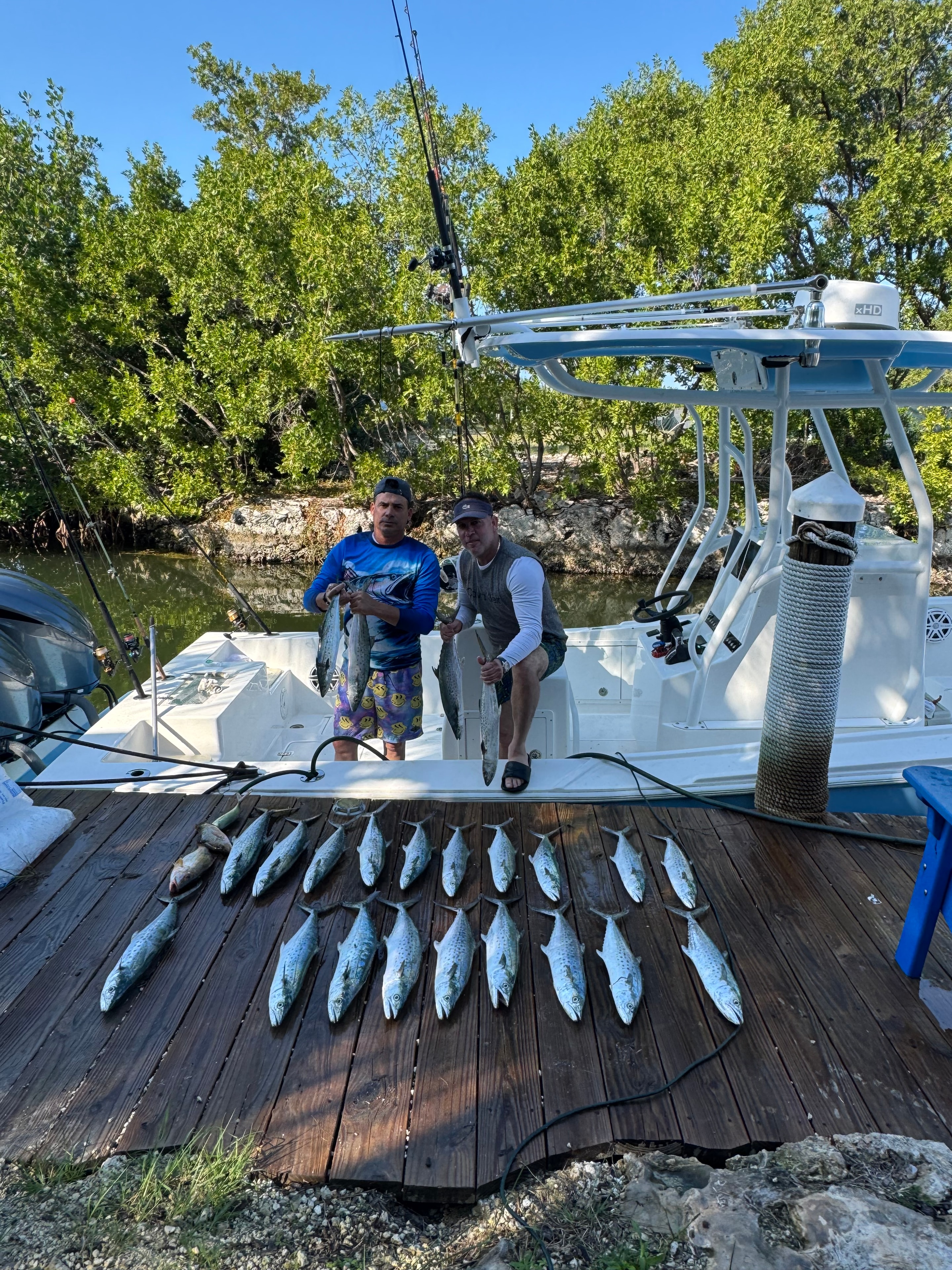Guests with a full catch of Spanish mackerel at the dock after a Mako 30ft fishing charter Miami