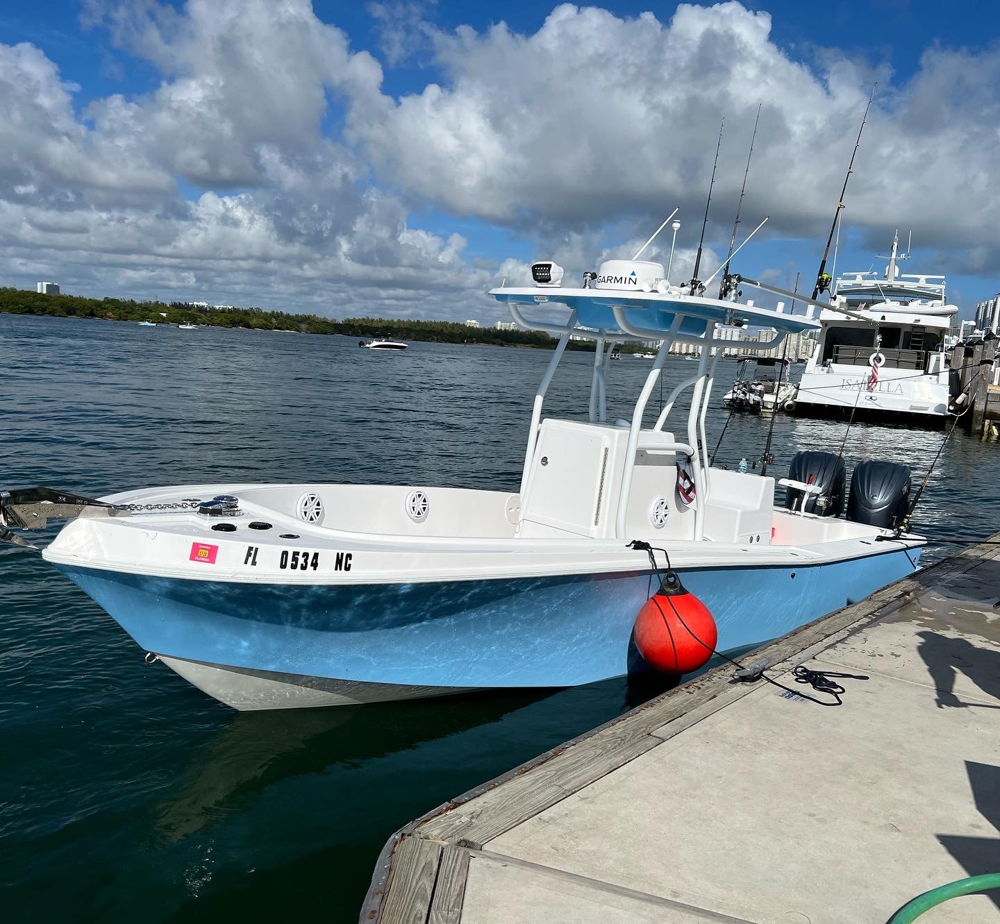 Mako 30ft helm station with Garmin chartplotter and Miami skyline in background