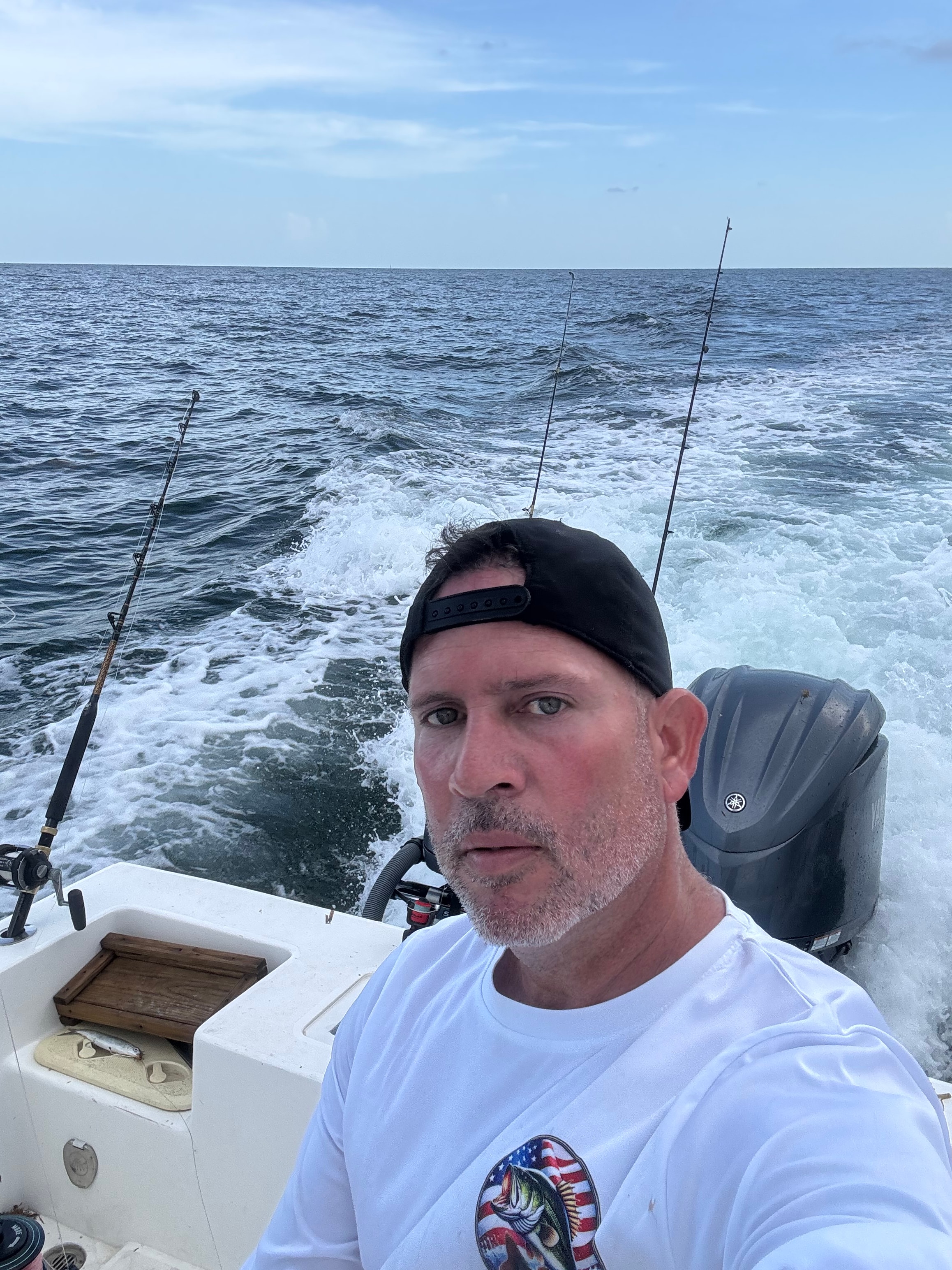 Mako 30ft Center Console profile view at marina with fishing rods rigged