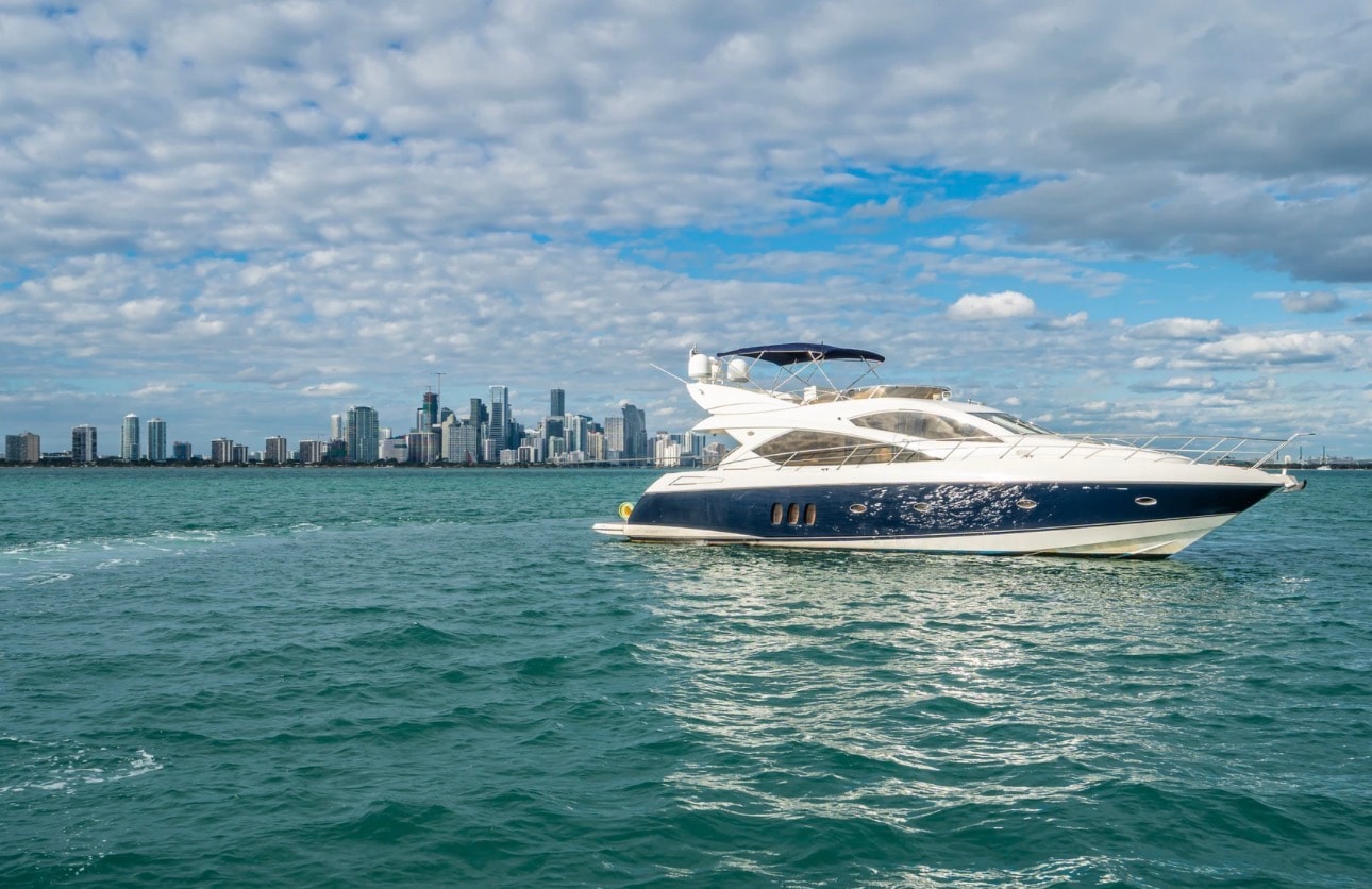Luxury yacht cruising past the Miami skyline on Biscayne Bay