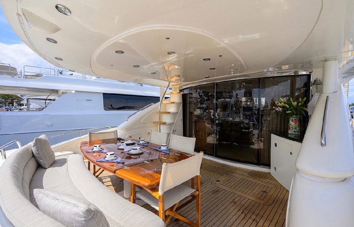 Sunseeker 88ft aft deck teak dining area with lounge seating — luxury yacht charter Miami