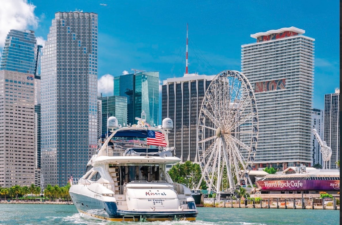 Sunseeker 88ft stern cruising past Miami skyline and Bayside observation wheel